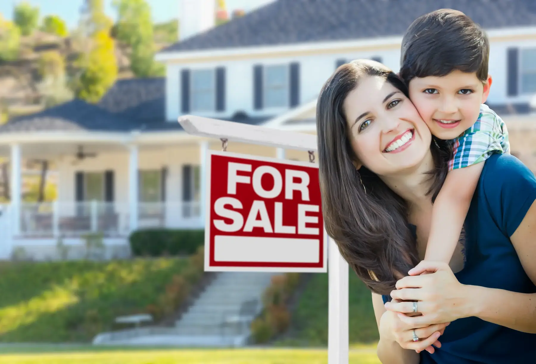 Family celebrating a home for sale in a suburban neighborhood